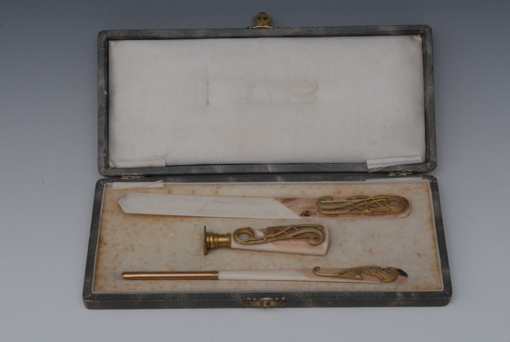 A French ivory writing set, comprising seal, pen and letter knife, each applied with a gilt metal