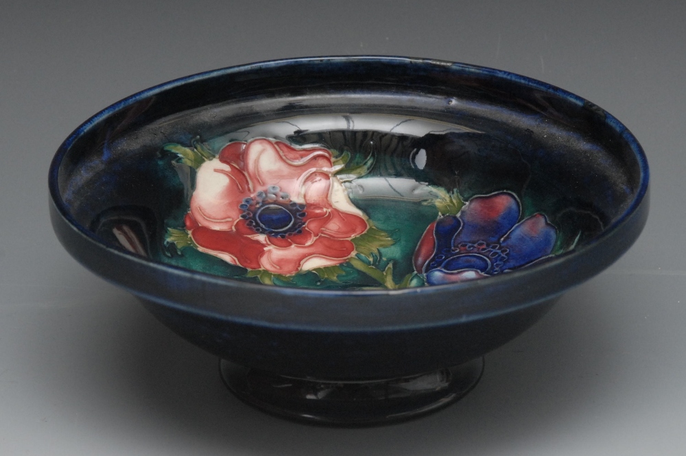 A Moorcroft Poppy pattern dish, tube lined with large flowerheads and foliage, on a cobalt blue