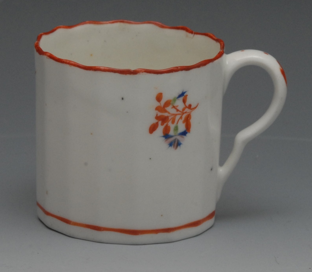 A Pinxton fluted coffee cup, pattern no. 1, painted in iron-red, blue, pink and green with