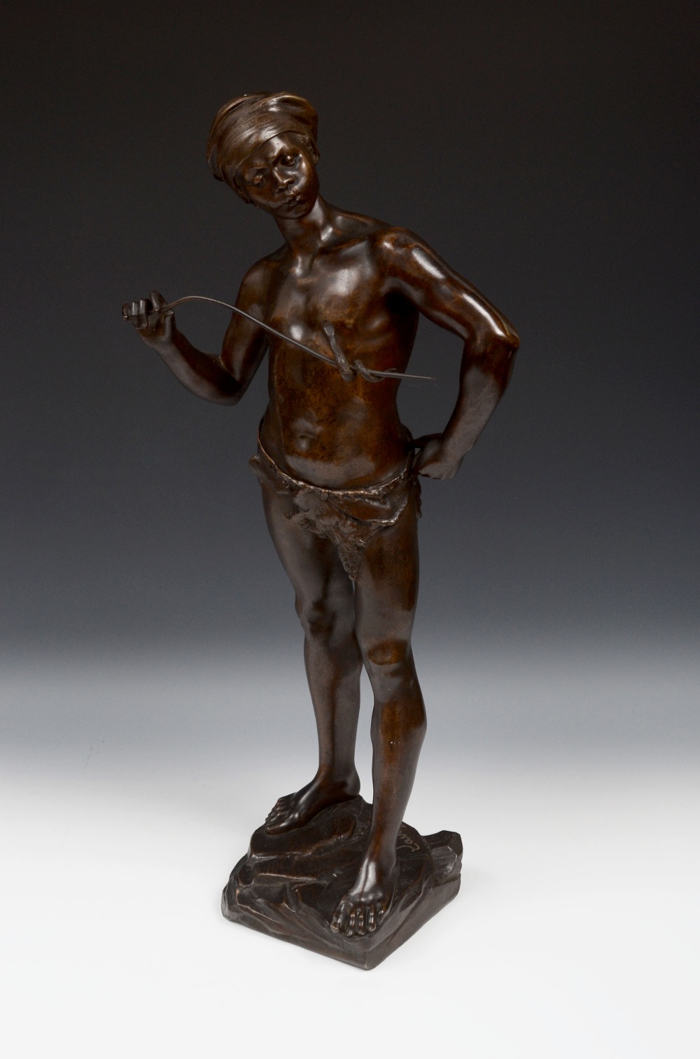 Adolphe Jean Lavergne (1863 - 1928), a brown patinated bronze, THe Snake Charmer, the African boy