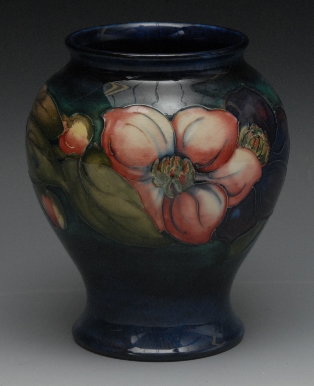 A Moorcroft Anemone pattern vase, tube lined with flowers and leaves, in tones of red, green and