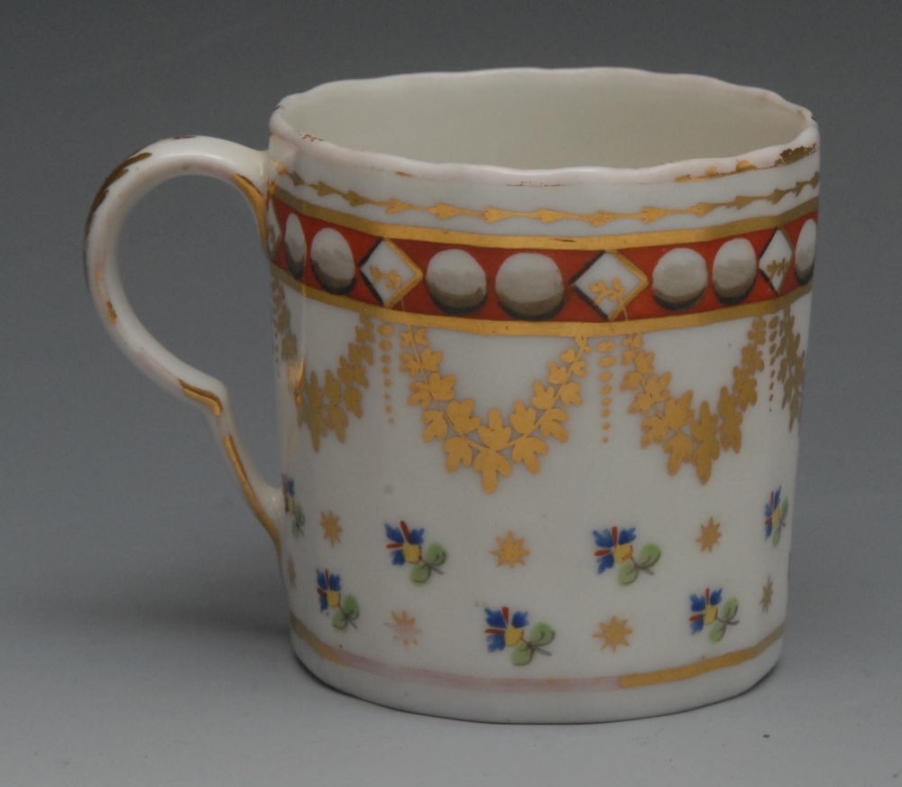 A Pinxton fluted coffee can, pattern no. 314, decorated with cornflower sprigs, below gilt swags