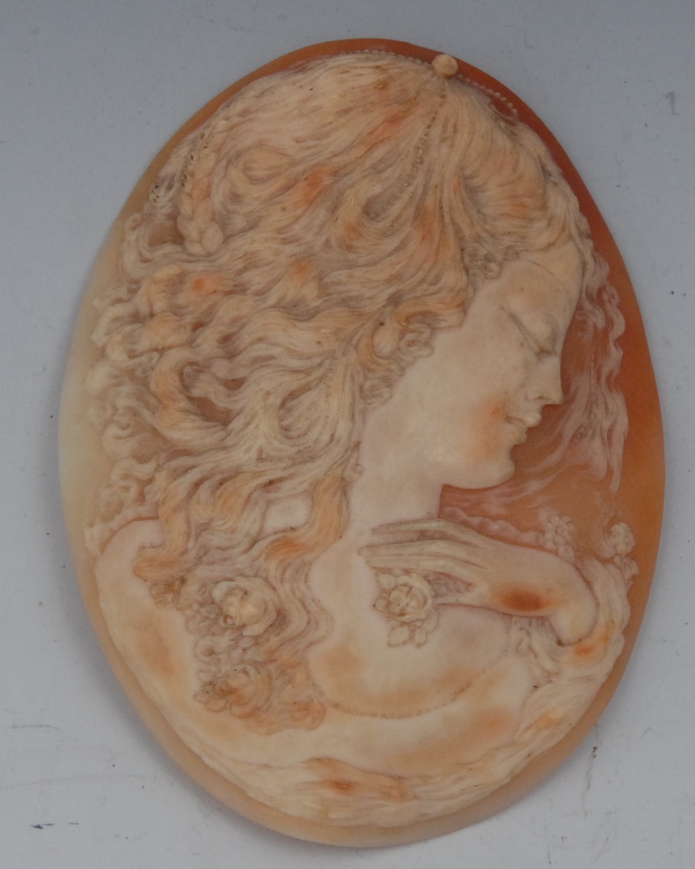 A large 19th century oval portrait cameo panel, carved with a flowing haired maiden facing right