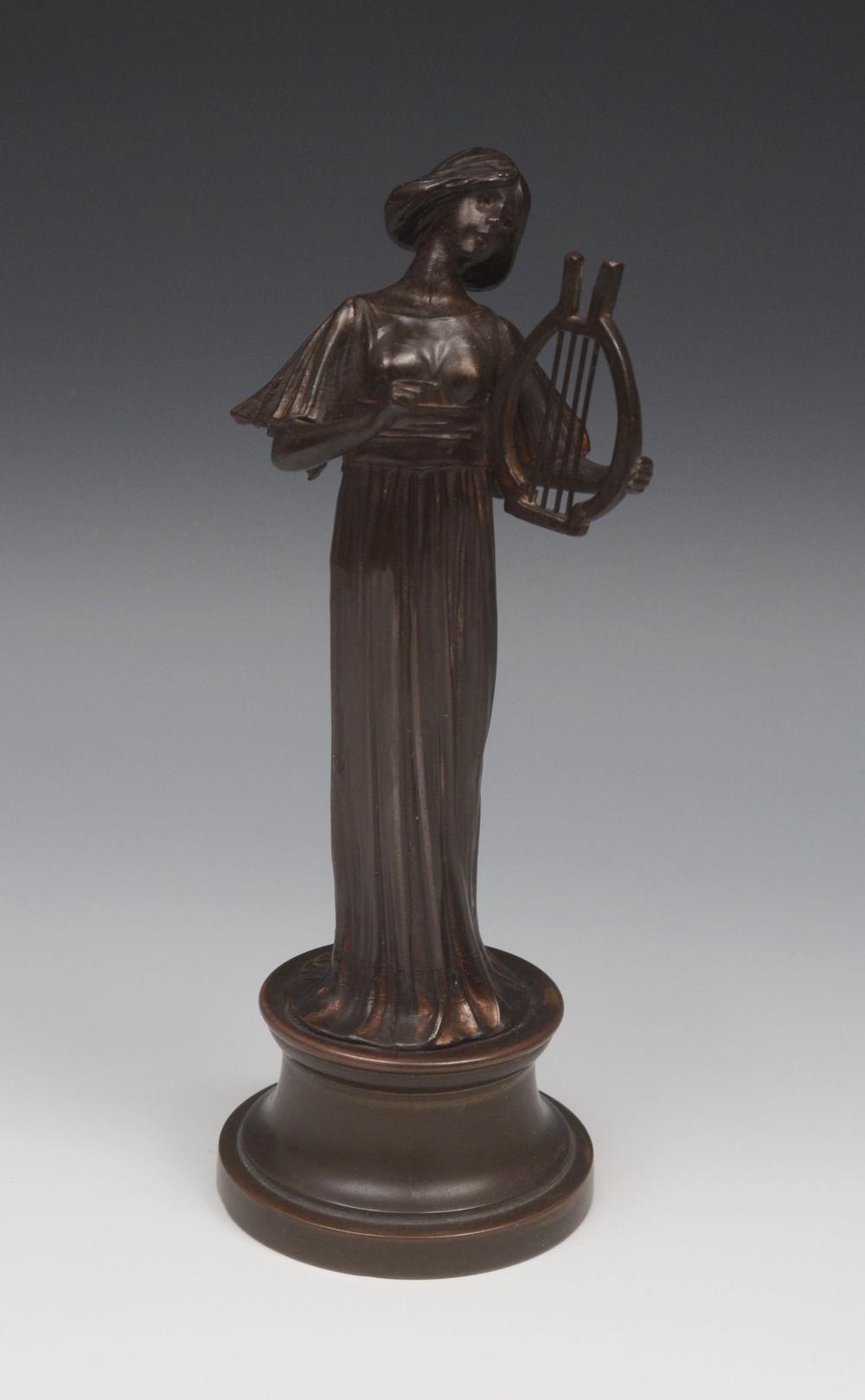 French School (late 19th/early 20th century), a dark patinated bronze, of a muse, she stands, in