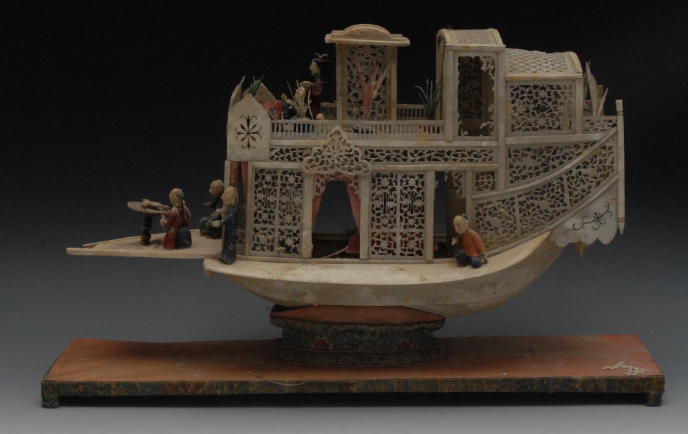 A Chinese Export carved ivory flower boat/junk, the intricately pierced and carved superstructure
