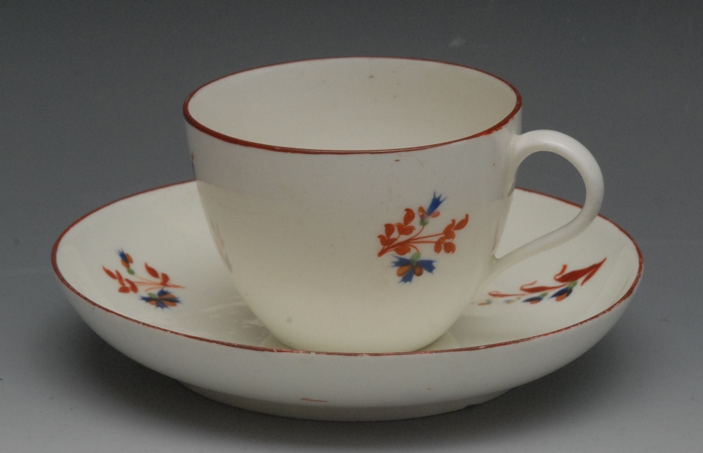 A Pinxton Bute shape teacup and saucer, pattern no.1, with Chantilly sprigs, iron red line border,