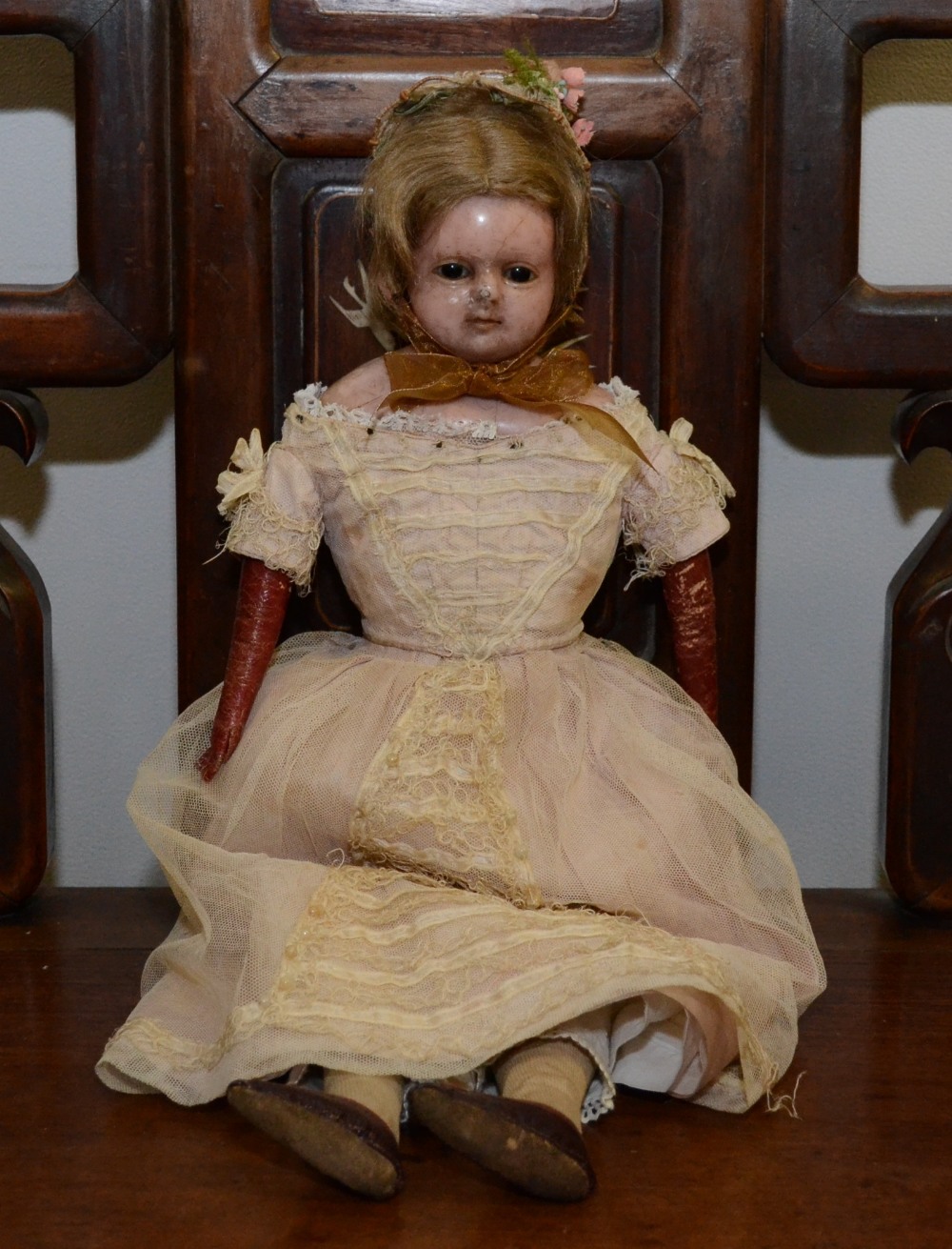 A late 19th century wax over composition head and shoulder doll, inset black glass eyes, partly