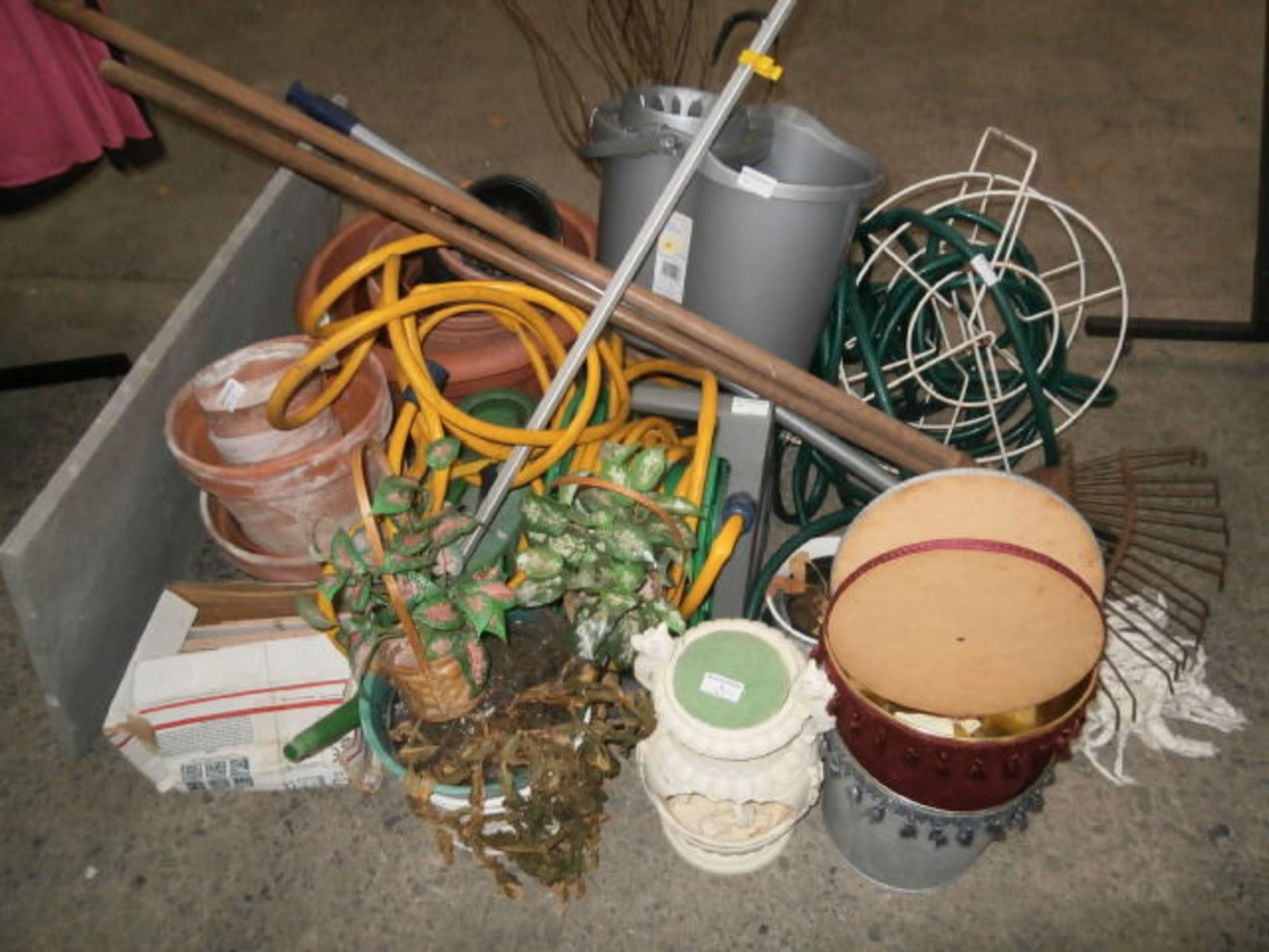 Selection of hoses and terracotta plant pots etc