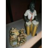 Figurine of African man playing drums and one other