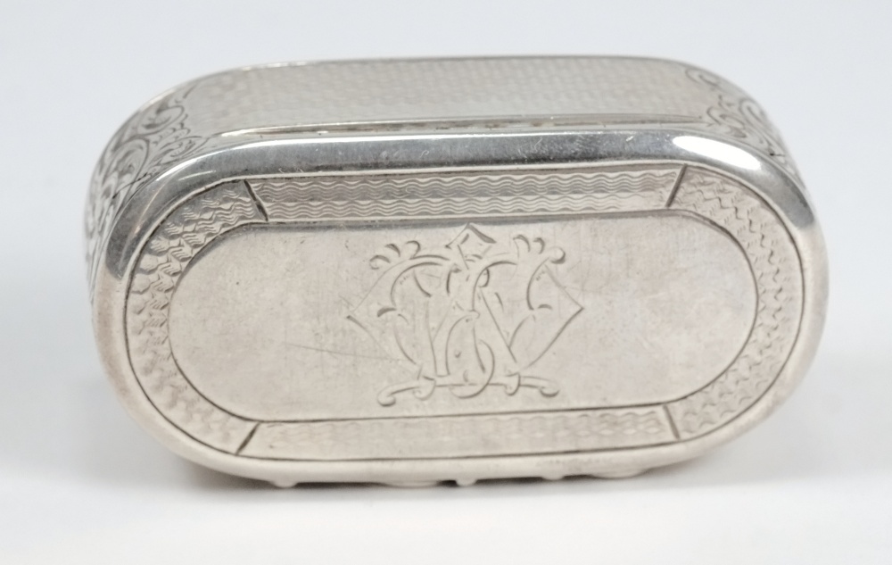 A Victorian silver snuff box, maker George Unite, Birmingham, 1864: initialled, of oval outline with