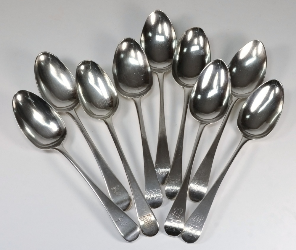 A collection of nine Georgian silver fiddle pattern tablespoons: monogrammed or crested, various