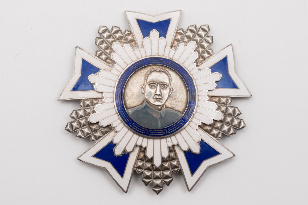 A Chinese silver and enamel star shaped medal: with relief portrait of possibly Chiang Kai-shek,