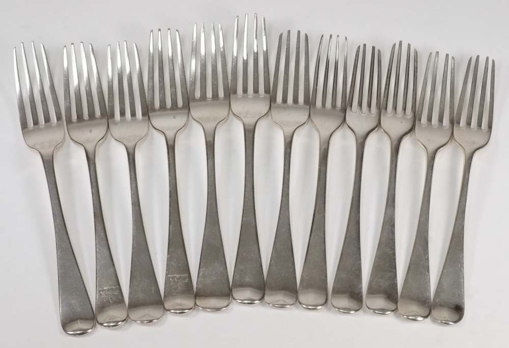 A collection of twelve Georgian silver Old English pattern dessert forks: mostly crested or