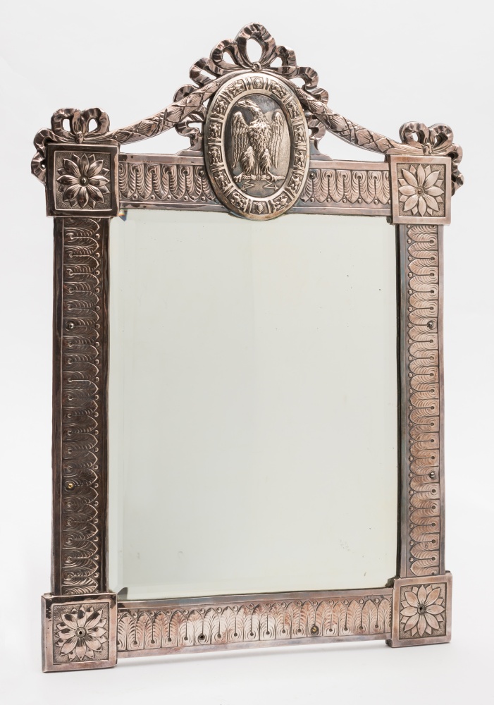 A 19th century German silver wall mirror:, the rectangular bevelled mirror plate enclosed by a