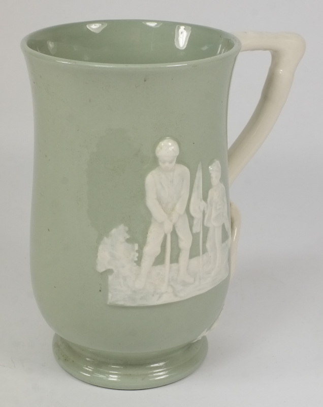 A Copeland Spode celadon glazed mug decorated with figures playing croquet and golf:, the handle in