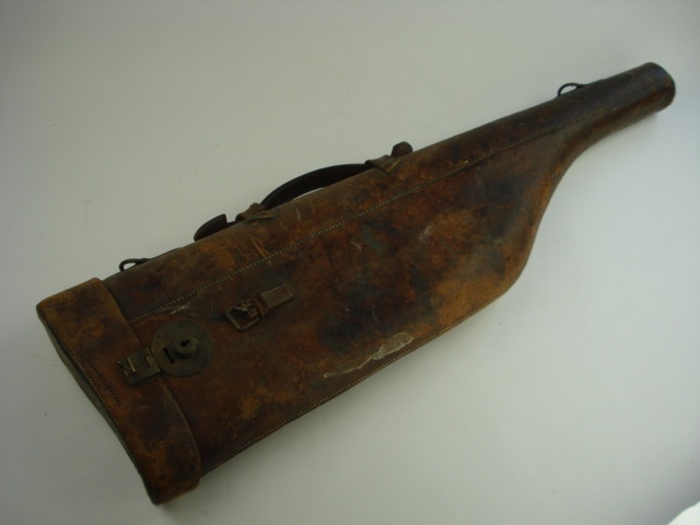 A  brown leather `leg o` mutton` gun case:.