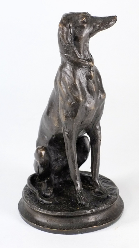 After Barye, a bronze study of a seated whippet: on a circular base, 16.5cm. high.