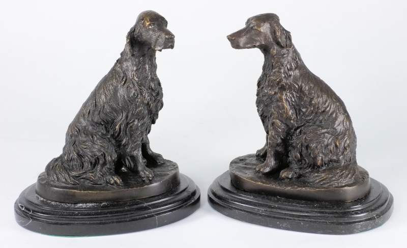 After Barye, a pair of bronze Spaniels: seated on oval bases 19cm. high.