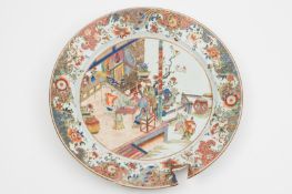 A large Chinese famille rose charger: painted with two ladies playing a game at a table on a