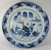 A large Chinese blue and white charger: painted with a lake landscape with a large willow tree and