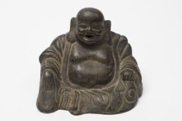 A Chinese bronze figure of Budai: the laughing deity wearing elaborate robes,  17th/18th century,