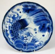 A Japanese Arita dish: painted with a large carp amongst waves, Meiji, 31cm diameter [chip to rim].
