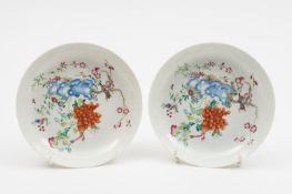 A pair of Chinese famille rose saucer dishes: each painted with a magpie, a large peony spray,