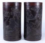 Two Chinese bamboo brush pots: both with carved panels of landscape vistas, 26 x 17cm. high.