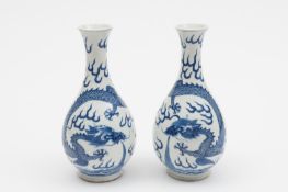 A pair of Chinese blue and white bottle vases: each with pear shaped body and waisted slender neck,