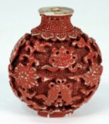 A Chinese porcelain `faux cinnibar lacquer` snuff bottle: of flattened circular form crisply and