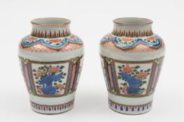 A pair of Chinese wucai baluster vases: in Wanli style, painted with panels of peony, chrysanthemum