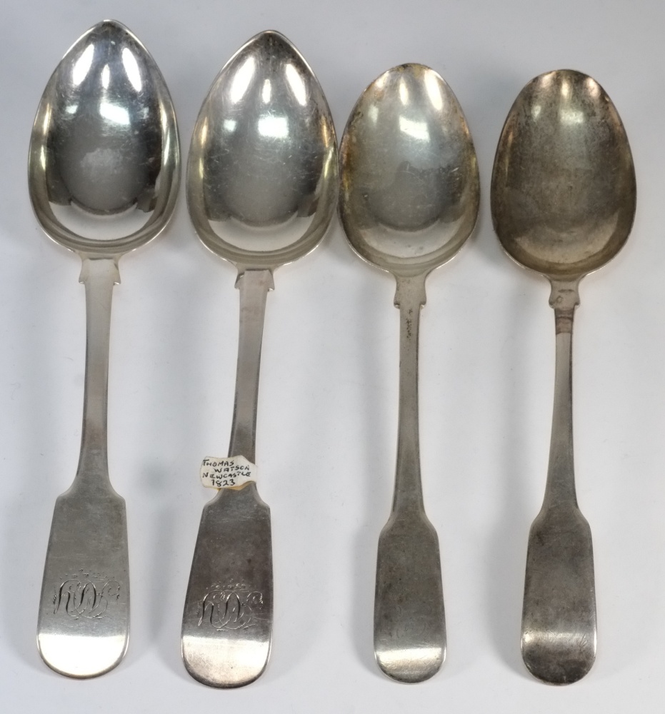 A pair of George IV fiddle pattern table spoons, maker Thomas Watson, Newcastle, 1823: and another