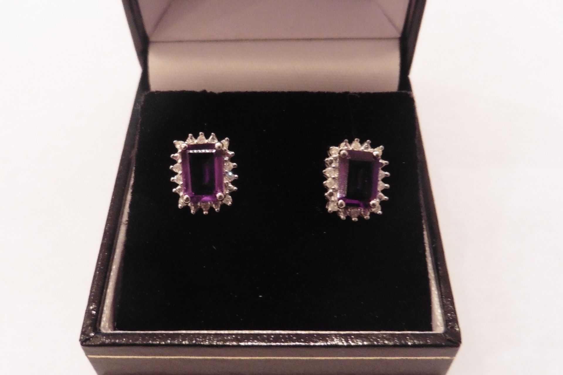 9ct white gold amethyst and diamond earrings each set with a emerald cut amethyst, total weight is 1