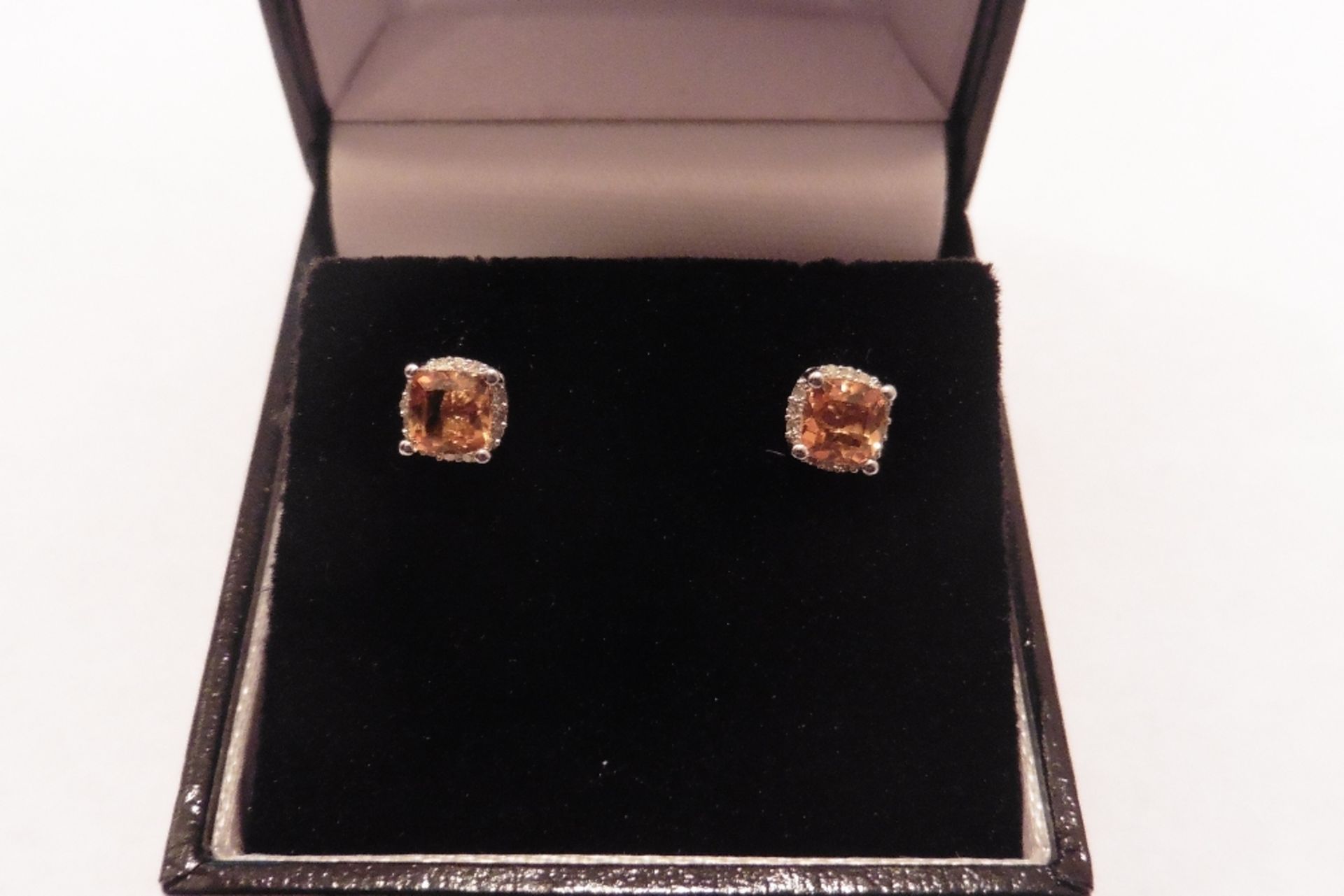 9ct white gold citrine and diamond earrings each set with a cushion cut citrine, total weight is 0.6
