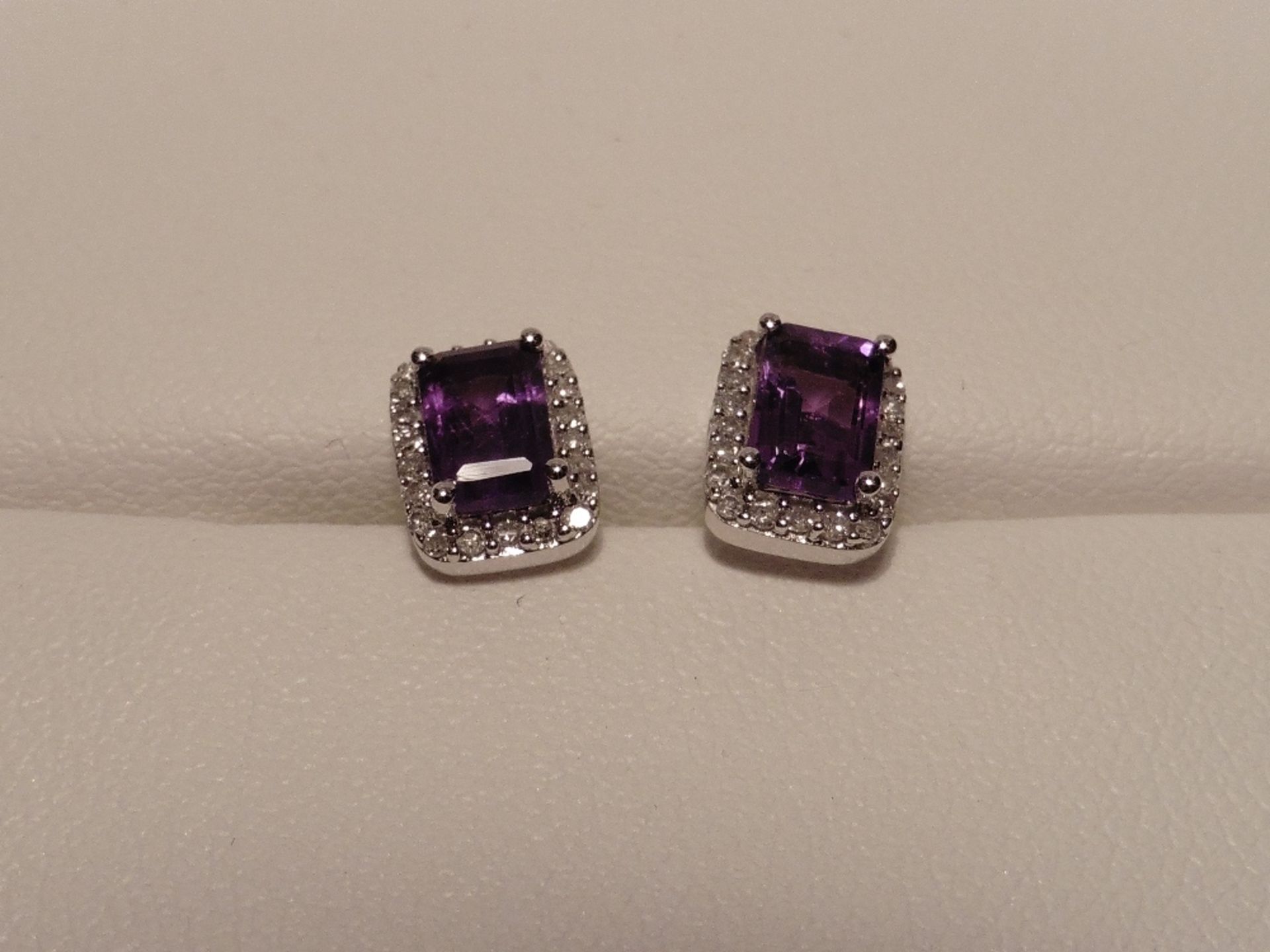9ct white gold amethyst and diamond earrings each set with a single emerald cut amethyst and surroun