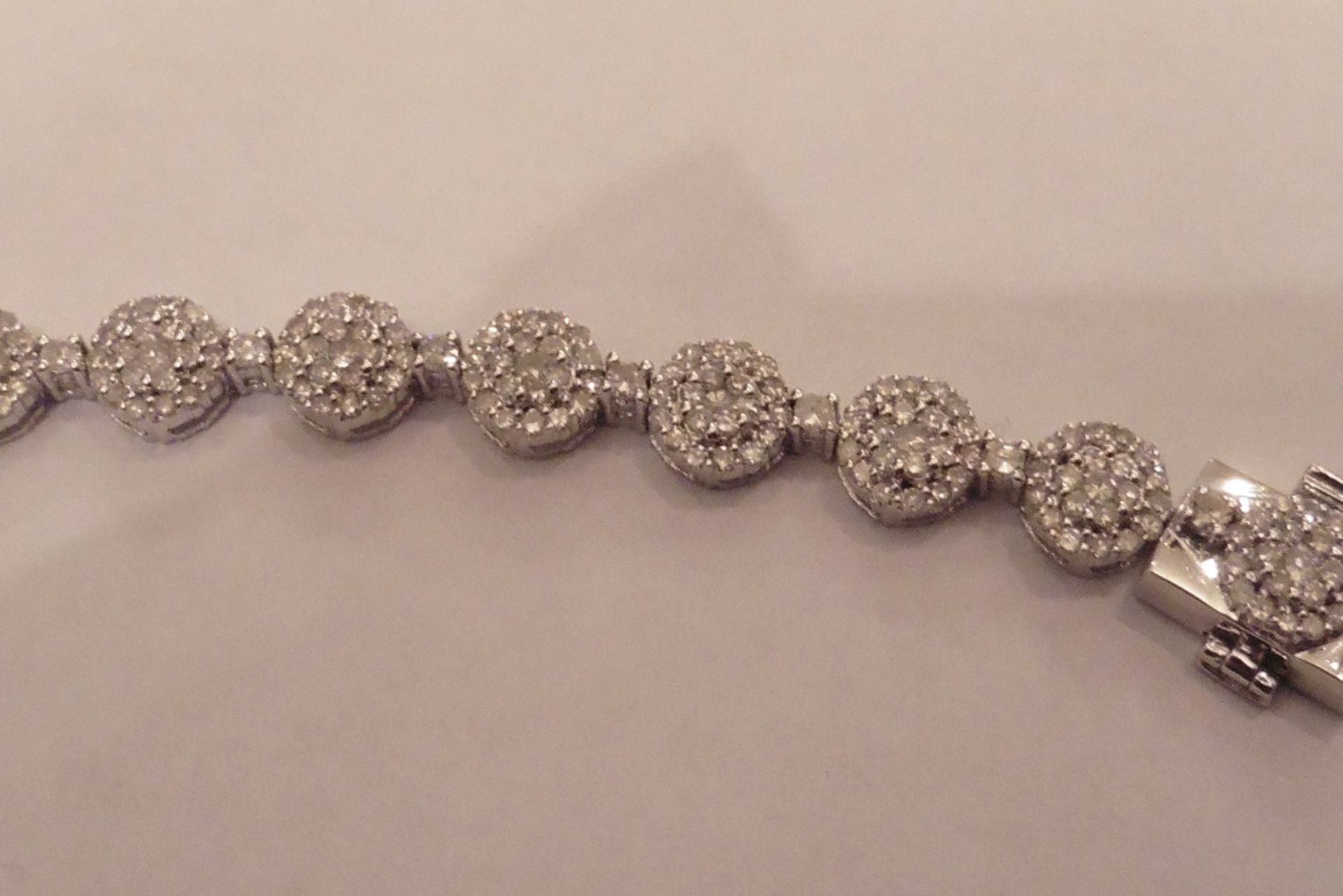 9ct white gold fancy diamond bracelet set with clusters of small round cut diamonds of I1/I2 clarity - Image 2 of 2
