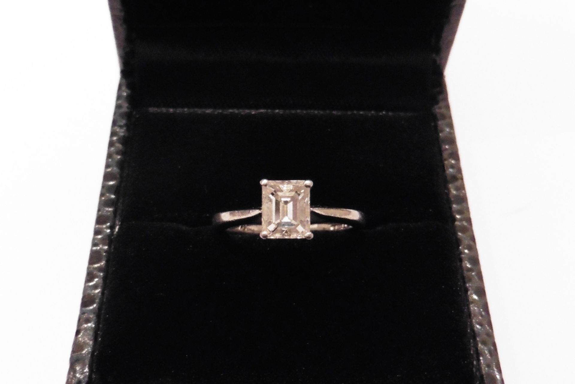 Simple but modern platinum solitaire hosting a VS emerald cut diamond of I colour weighing 1.00ct.