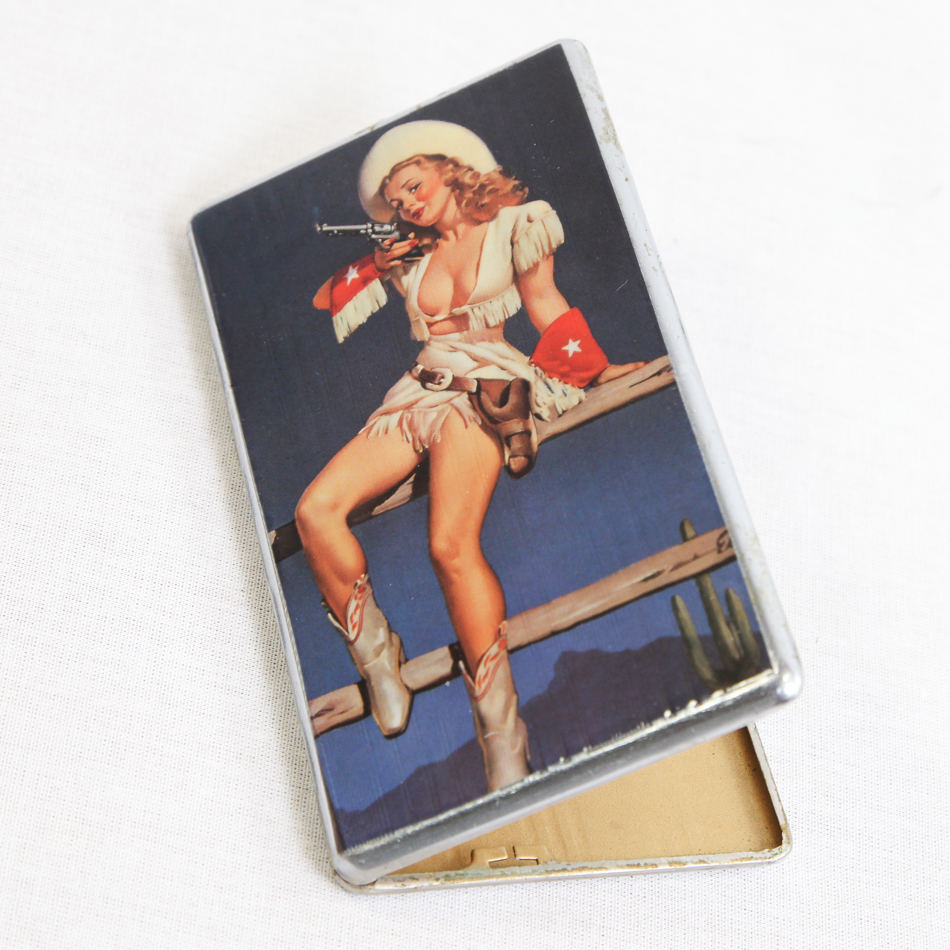Vintage cigarette case, lid decorated with Annie get your gun pin-up girl