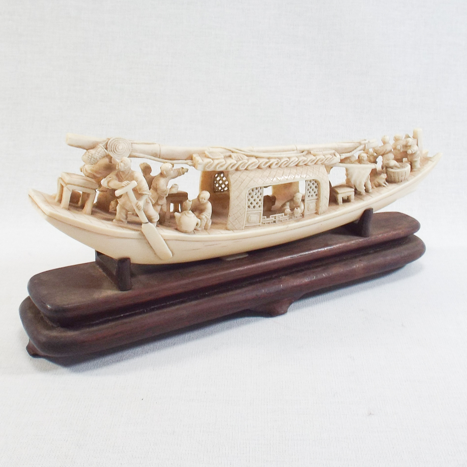 Early 20th century Meiji Japanese carved ivory model of a Junk with figures on hardwood stand,