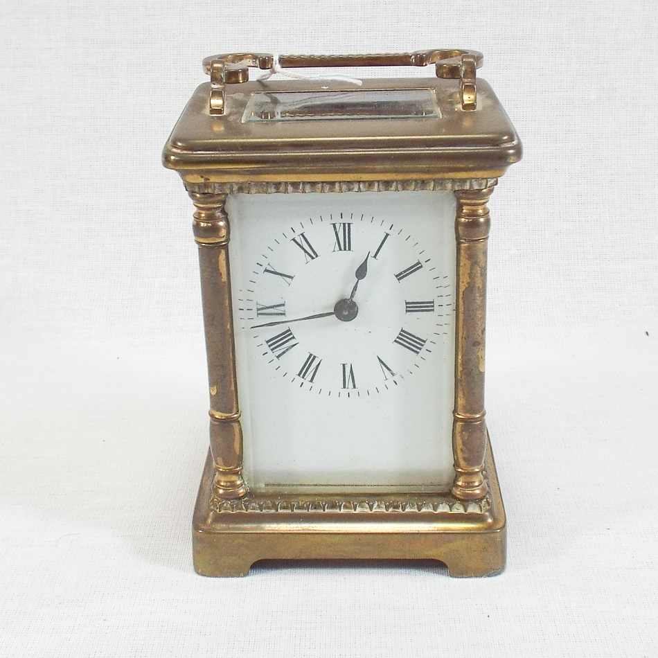 Brass and glass case carriage clock, white enamel face, column supports, complete with key, 15 cm