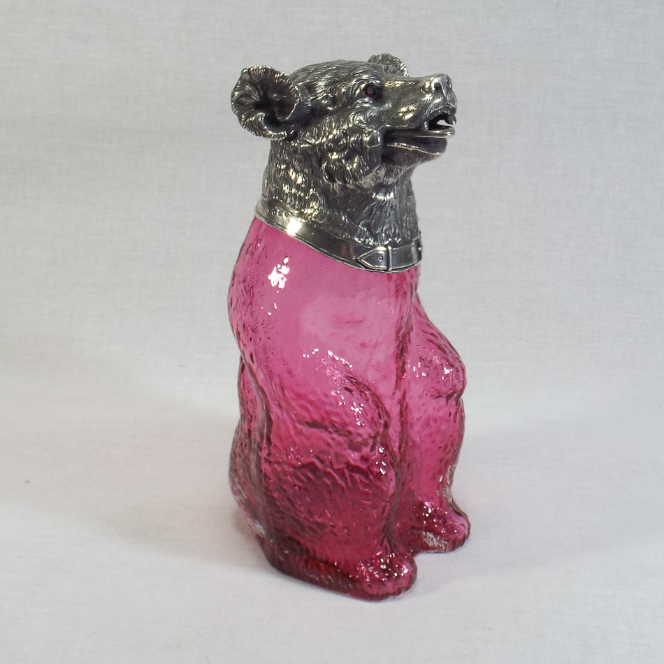 Victorian style cranberry glass claret jug modelled as a bear with silver plated head inset glass