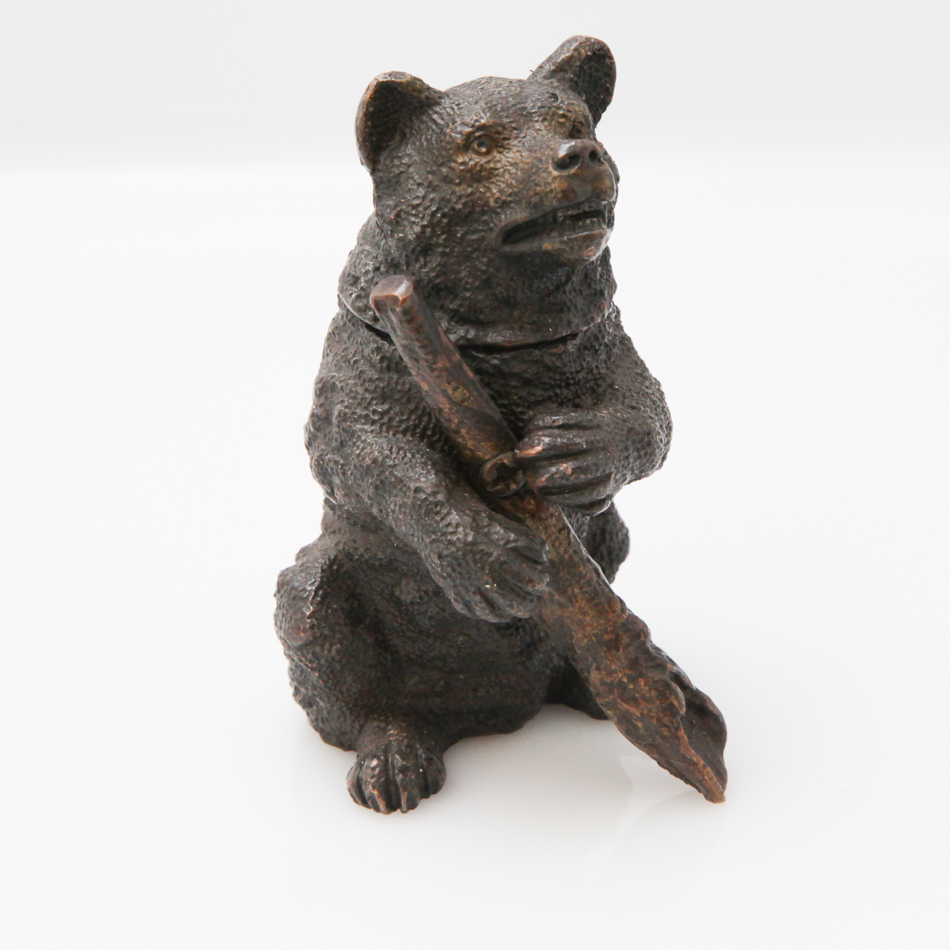 Small cold painted bronze ink well in the form of a seated bear holding a branch, 7 cm high