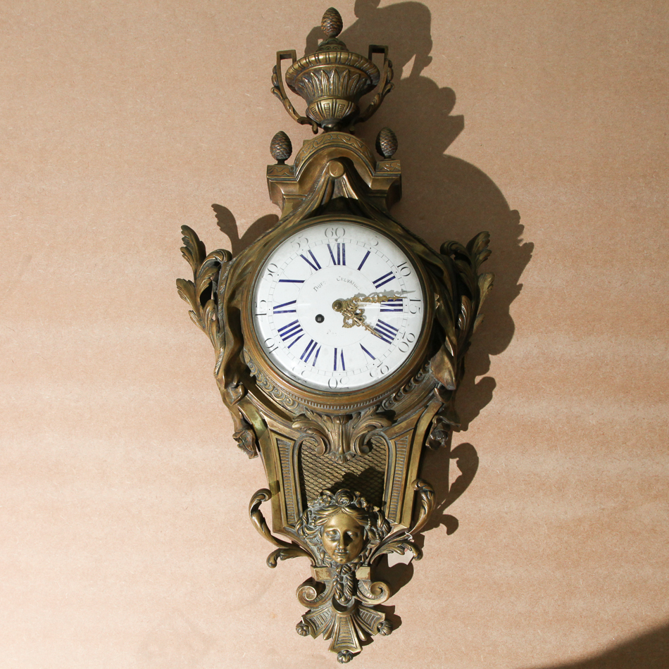 Heavy French gilded bronze cartel clock with striking movement, approx 3 ft high