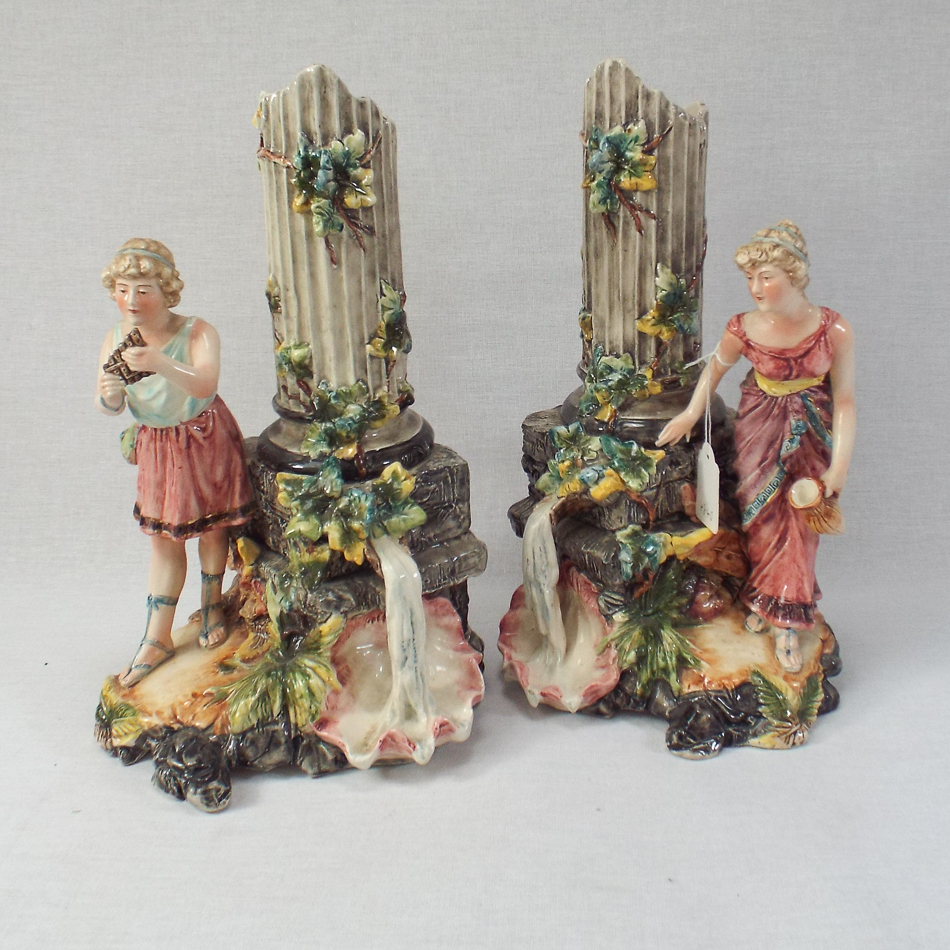 Pair of 19th century continental pottery figural style vases with ruinous column decoration, each in