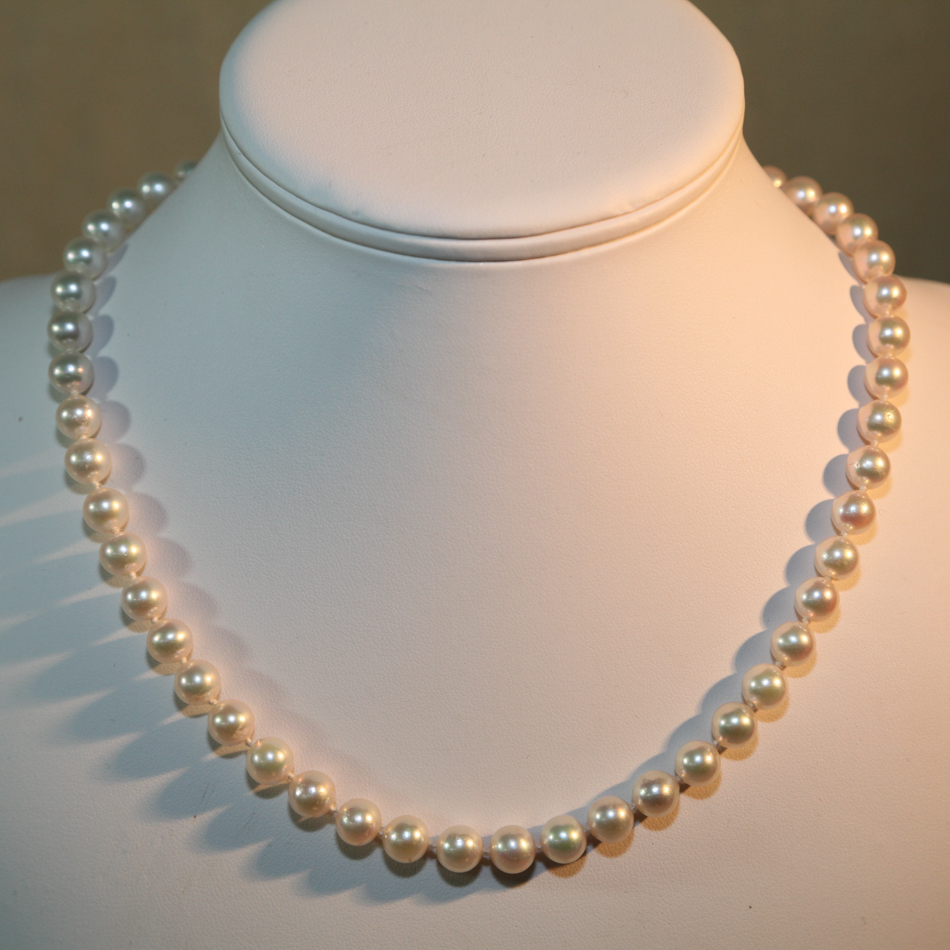 Uniform row of 53 cultured pearls on an 18ct yellow gold bead style clasp set with 4 brilliant cut