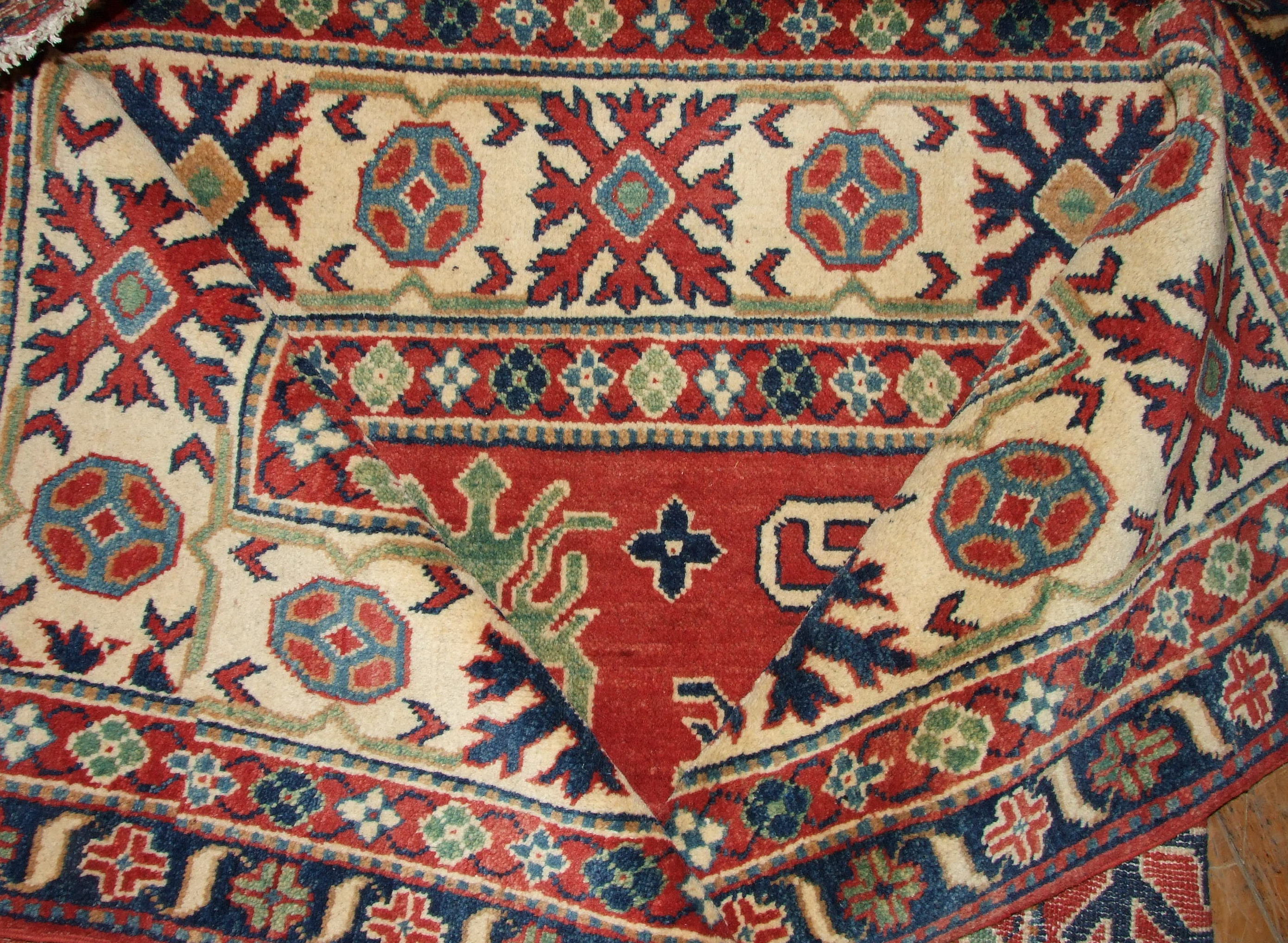 A Kazak carpet, with geometric motifs, on a red ground, within a multi border, 293 x 197 cm - Image 2 of 3
