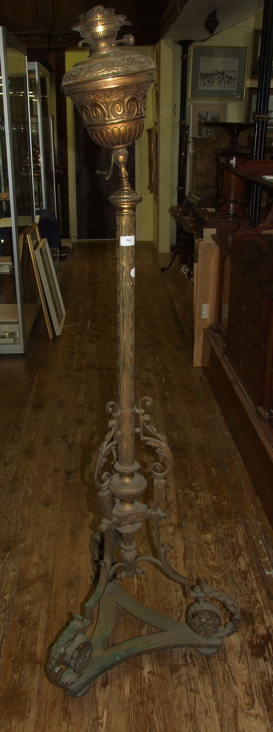 A Victorian ecclesiastical style brass standard oil lamp, and two acanthus leaf scroll brackets (3)