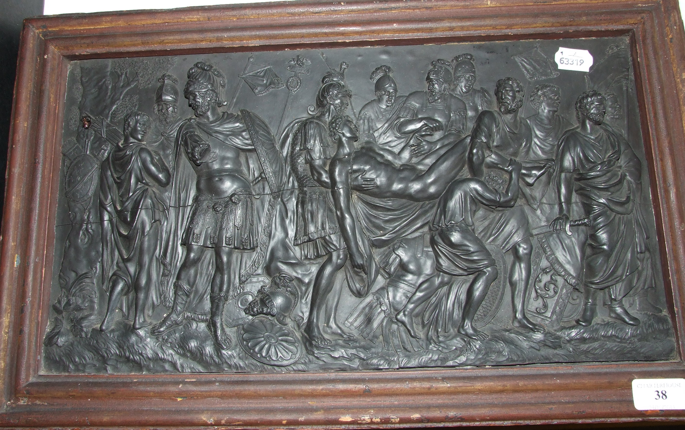 A Wedgwood style black basalt plaque, 'The Death of a Roman Warrior', 26 x 49 cm, framed (repaired)