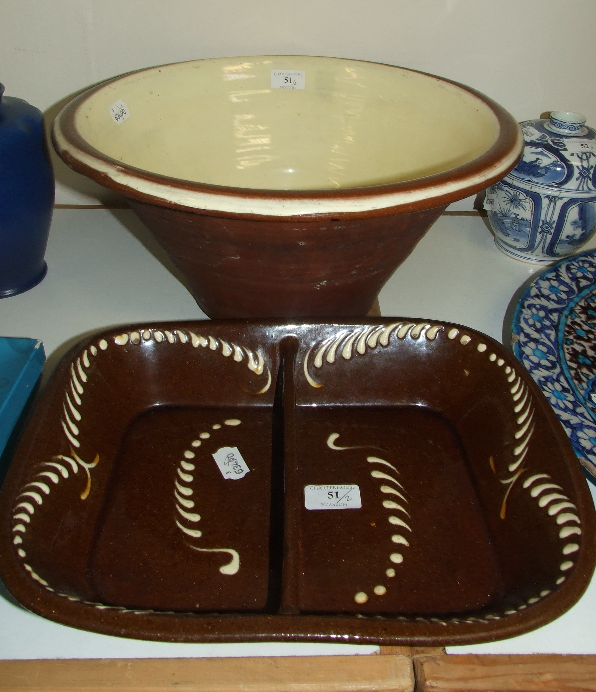 A 19th century slipware dish, 35.5 cm wide, and a similar wash bowl, 41.5 cm diameter (a.f.) (2)