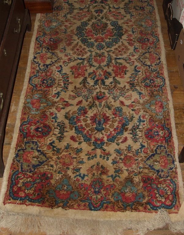 A Persian style runner, with floral decoration on a cream ground, 315 x 67 cm